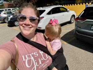 Mom with toddler at Story Land, New Hampshire, wearing a TushBaby carrier.