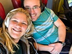 Couple relaxing on a train from Florence to Rome, Italy, during their honeymoon adventure.